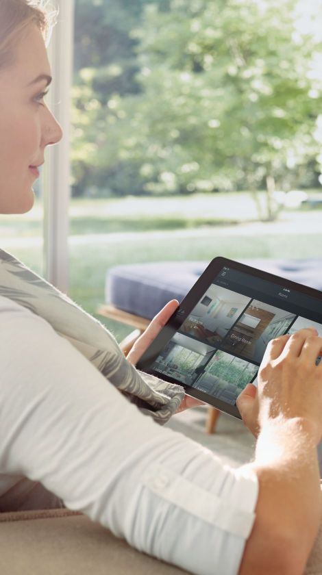 Woman sitting interacting with a tablet